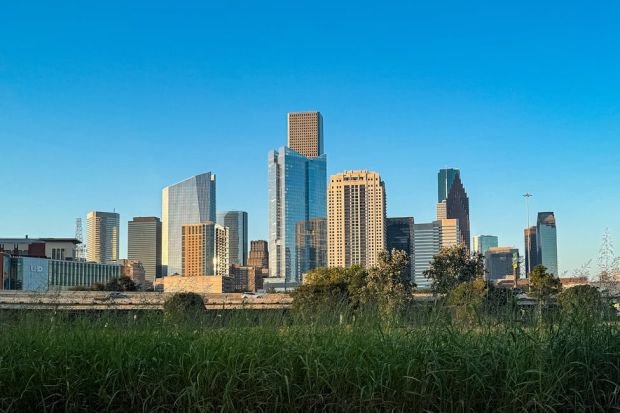 Stunning view of Houston's skyline under a bright blue sky, showcasing modern architecture.